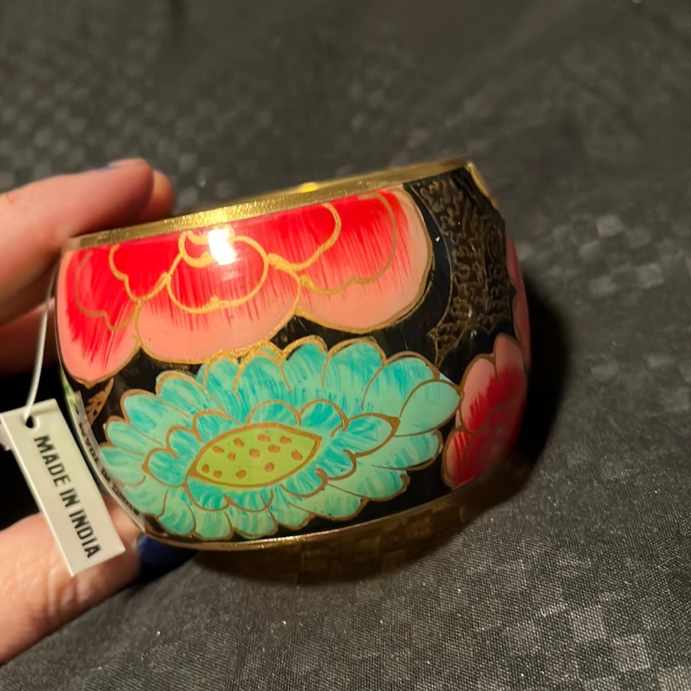 Gorgeous gold inlayed Indian cuff bracelet trimed in gold toned accents.